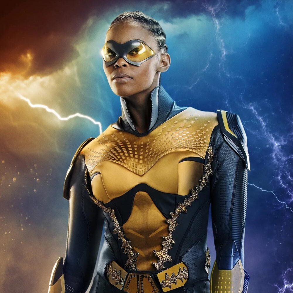 A lesbian superhero wearing a dark blue and yellow costume.