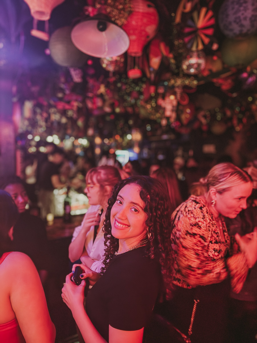 A woman partying inside a NYC lesbian bar.