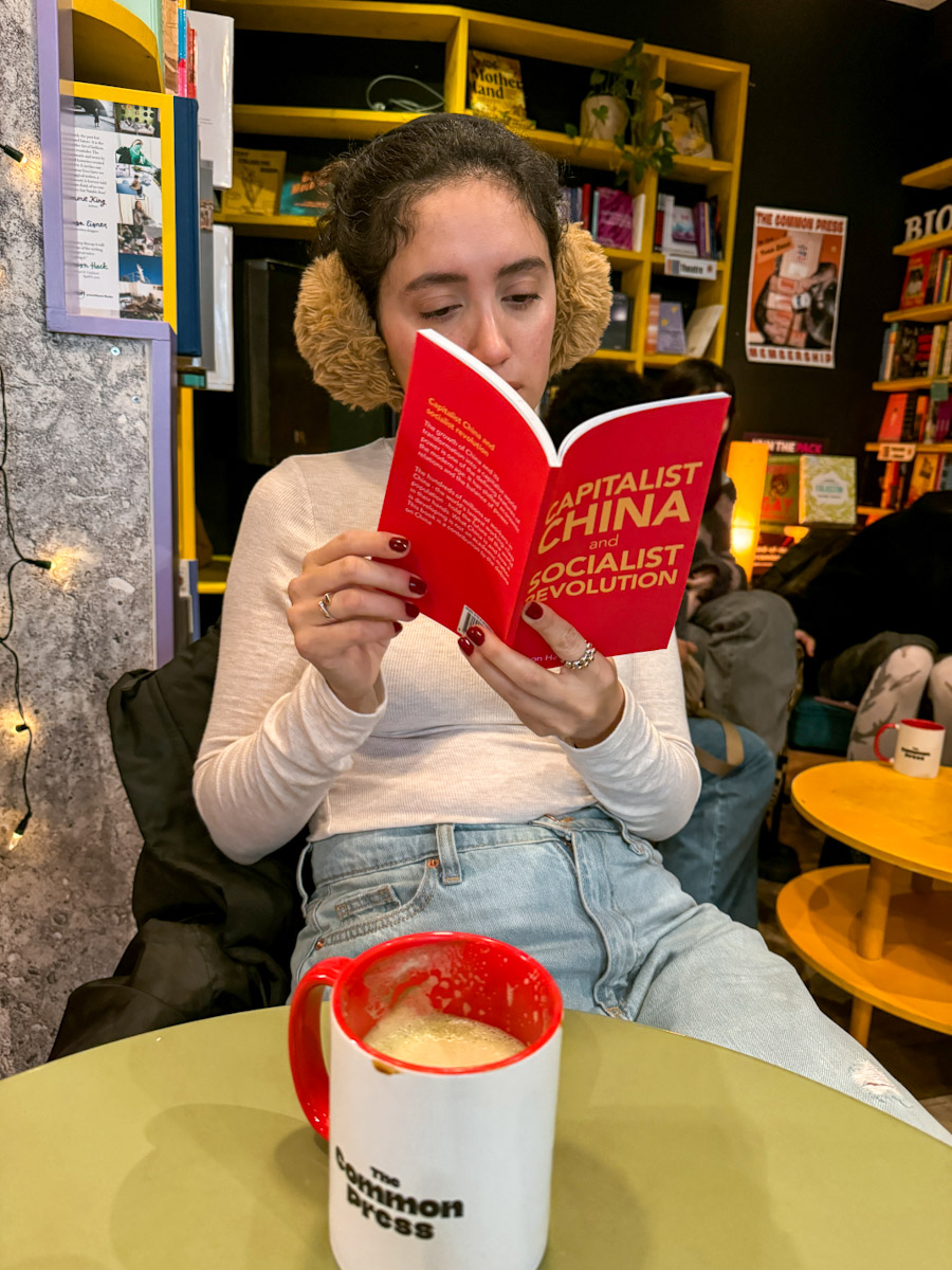 A woman reading a book inside a London lesbian space.