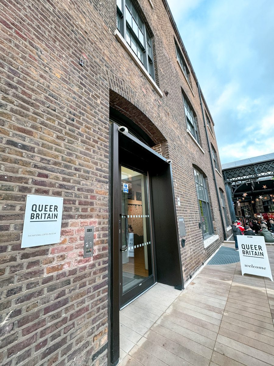 The entrance of a queer museum in London with brick walls.
