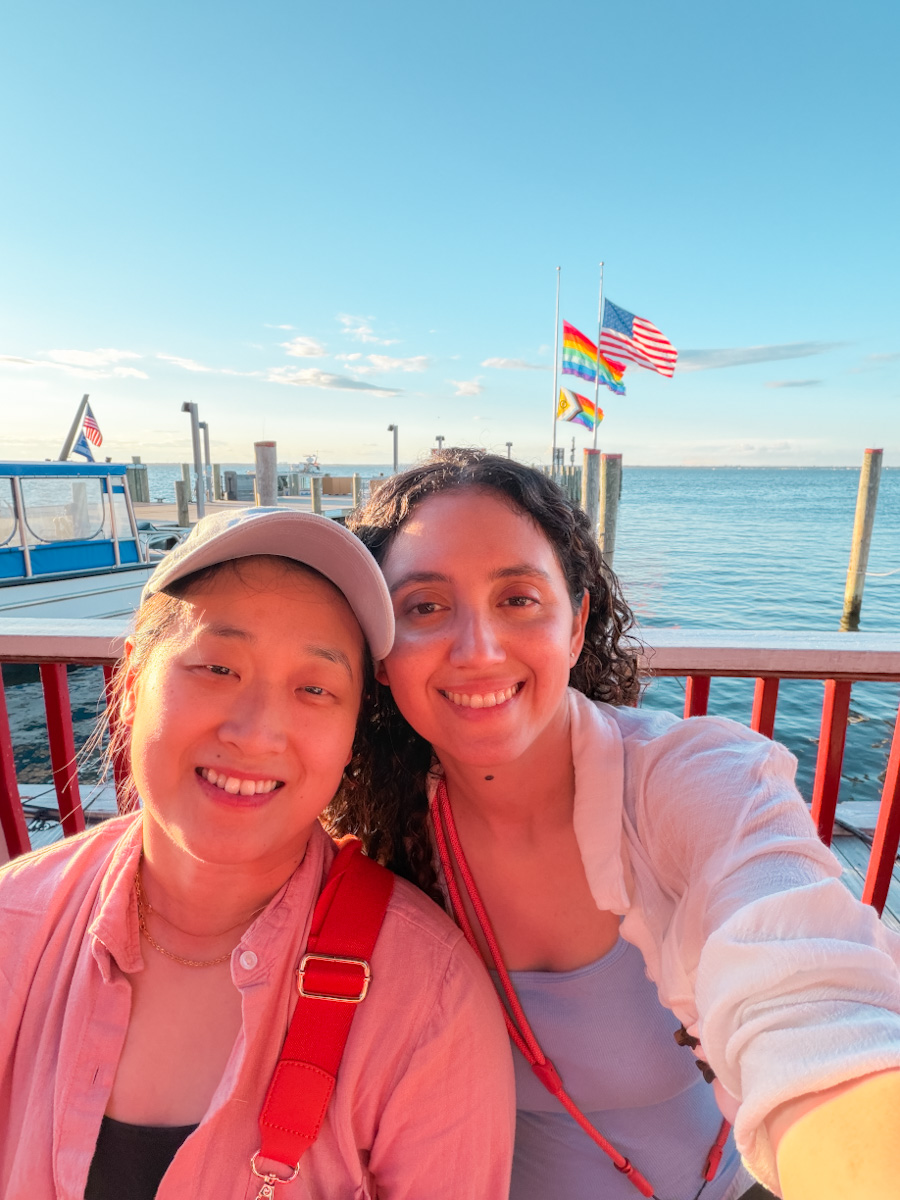 Two women taking a selfie by the sea in Cherry Grove, Fire Island in New York.