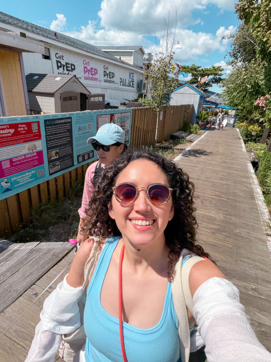 Two women walking on a wooden walkway in Cherry Grove, Fire Island in New York.