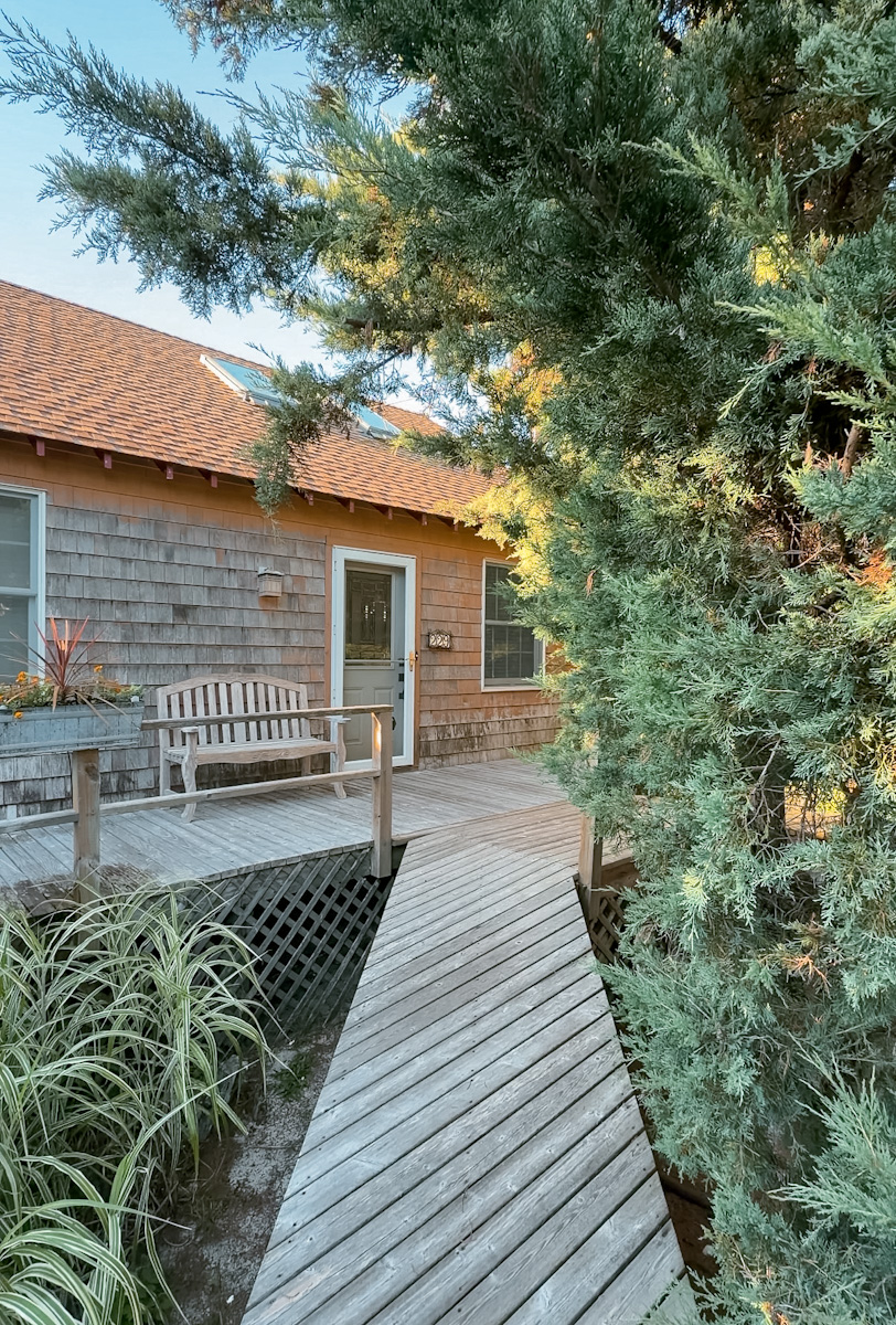 A home with a wooden walkway and a garden in Cherry Grove, Fire Island in New York.